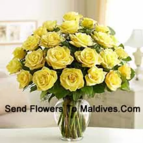 24 Yellow Roses With Some Ferns In A Glass Vase