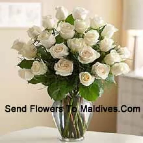 24 White Roses With Some Ferns In A Glass Vase