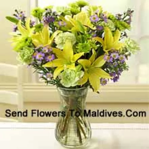 Yellow Lilies And Other Assorted Flowers Arranged Beautifully In A Glass Vase