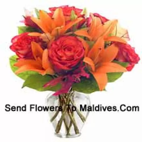 Orange Lilies And Orange Roses With Seasonal Fillers Arranged Beautifully In A Glass Vase