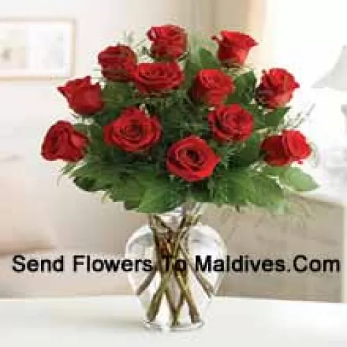 12 Red Roses With Some Ferns In A Glass Vase