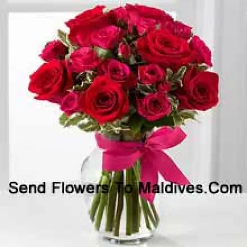 18 Red Roses With Seasonal Fillers In A Glass Vase Decorated With A Pink Bow